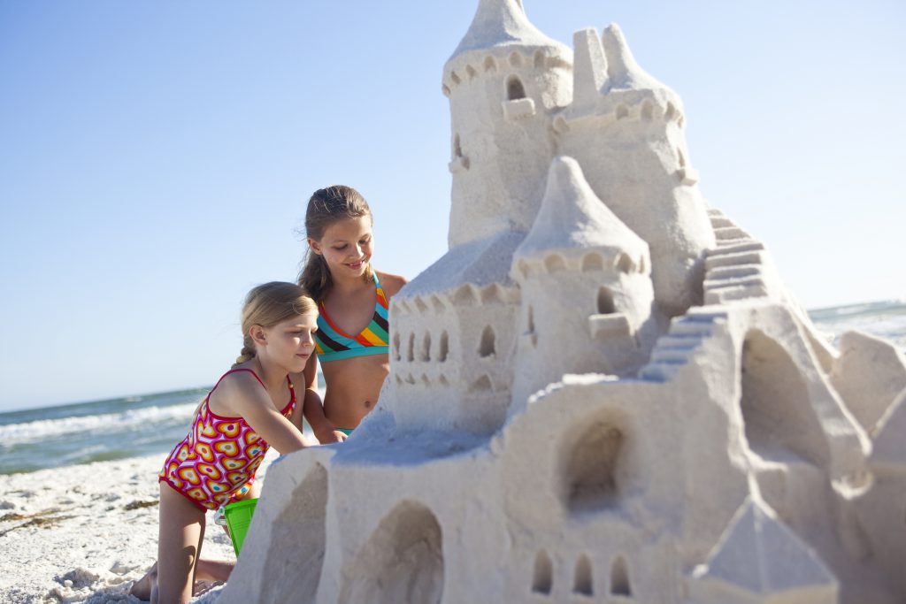 Children building sand castle on the beach